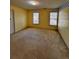 Neutral-toned bedroom features plush carpet, two windows, and natural light at 136 Hunters Ct, Dallas, GA 30157