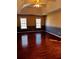 Spacious bedroom with hardwood floors, overhead fan, and bright windows at 136 Hunters Ct, Dallas, GA 30157