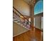 Bright foyer featuring hardwood floors, a staircase, a chandelier, and a large arched window at 136 Hunters Ct, Dallas, GA 30157