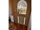 Grand foyer featuring a chandelier, large arched window, hardwood floors, and front door at 136 Hunters Ct, Dallas, GA 30157