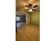 Open living room featuring tile floors, a ceiling fan, and an open doorway at 136 Hunters Ct, Dallas, GA 30157