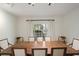 Bright dining room features a wooden table, six chairs, and a window overlooking the backyard at 17 Blackland Rd, Atlanta, GA 30342