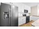 Well-equipped kitchen featuring stainless steel appliances, granite countertops, and white cabinetry at 209 Windsor Green Ct, Canton, GA 30115