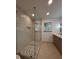 Contemporary bathroom featuring a frameless glass shower with mosaic tile flooring and a double sink vanity at 3629 Stewart Rd, Atlanta, GA 30340