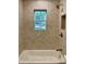 Bathroom featuring stylish tiles, a window view, and sleek bronze hardware at 3629 Stewart Rd, Atlanta, GA 30340