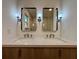 Elegant bathroom with a double sink vanity, featuring modern mirrors, beautiful sconces, and sleek faucets at 3629 Stewart Rd, Atlanta, GA 30340