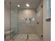 Bathroom showcasing a frameless glass shower with mosaic flooring and tile walls, complemented by modern fixtures at 3629 Stewart Rd, Atlanta, GA 30340