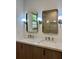 Bright bathroom featuring a double sink vanity with modern fixtures, stylish mirrors, and attractive lighting at 3629 Stewart Rd, Atlanta, GA 30340