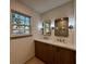 Bright bathroom featuring double sink vanity, framed mirrors, sconces, and a clear view of the large, tiled shower at 3629 Stewart Rd, Atlanta, GA 30340