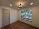 Well-lit bedroom with a view, hardwood floors, recessed lighting, and a modern light fixture at 3629 Stewart Rd, Atlanta, GA 30340