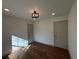 Sunlit bedroom with hardwood floors, neutral paint, and a modern light fixture at 3629 Stewart Rd, Atlanta, GA 30340