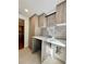 Functional laundry area with a countertop, storage cabinets, and modern tile backsplash for added style and convenience at 3629 Stewart Rd, Atlanta, GA 30340