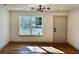 Bright living room featuring hardwood floors, a modern lighting fixture and white walls at 3629 Stewart Rd, Atlanta, GA 30340