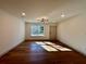Bright living room featuring hardwood floors and a modern lighting fixture at 3629 Stewart Rd, Atlanta, GA 30340