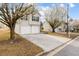 Two-story home featuring a two-car garage and a long driveway lined with lovely flowering trees at 4314 Ward Bluff Ct, Ellenwood, GA 30294