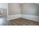 Bright living room featuring gray walls, chair rail, hard wood floors, and a view of the exterior at 4314 Ward Bluff Ct, Ellenwood, GA 30294