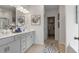 Bathroom featuring double sinks, gray cabinets, and a walk-in closet at 525 Lanier Way, Temple, GA 30179