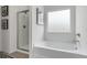 Bathroom featuring a glass shower, bathtub, and window with custom design at 525 Lanier Way, Temple, GA 30179