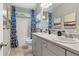 Bathroom featuring double sinks, framed art, and blue curtains at 525 Lanier Way, Temple, GA 30179