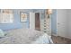 This bedroom has soft blue walls and accents of flowers and pictures at 525 Lanier Way, Temple, GA 30179