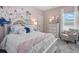 Floral themed bedroom with decorative wall art, a cozy chair, and lots of natural light at 525 Lanier Way, Temple, GA 30179