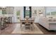 Open-concept dining area connecting the kitchen and living room, featuring a long wooden table and comfortable seating at 525 Lanier Way, Temple, GA 30179