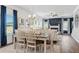 Bright dining room with a wooden table, chandelier, and windows overlooking the backyard at 525 Lanier Way, Temple, GA 30179