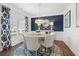 Elegant dining room featuring a modern chandelier, stylish decor, and ample natural light from the large window at 525 Lanier Way, Temple, GA 30179