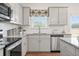 Bright kitchen featuring stainless steel appliances, granite countertops, and ample storage space at 525 Lanier Way, Temple, GA 30179