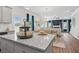 Modern kitchen features a large island with granite countertops and stainless steel appliances at 525 Lanier Way, Temple, GA 30179