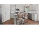Modern kitchen featuring stainless steel appliances, granite countertops, an island with seating, and stylish cabinetry at 525 Lanier Way, Temple, GA 30179