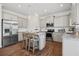 Spacious kitchen boasting stainless steel appliances, a center island with seating, and elegant pendant lighting at 525 Lanier Way, Temple, GA 30179