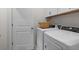 Functional laundry room featuring white appliances and a woven basket at 525 Lanier Way, Temple, GA 30179