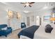 Bright bedroom featuring tray ceiling, a set of framed prints, and blue accent chair at 525 Lanier Way, Temple, GA 30179