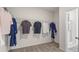 Walk-in closet featuring hanging racks and neutral colored carpet at 525 Lanier Way, Temple, GA 30179