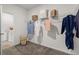 Spacious walk-in closet with rod iron shelving and neutral colored carpet at 525 Lanier Way, Temple, GA 30179