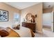 Bright bedroom featuring a modern dresser, round mirror, and ample natural light at 5724 Schelton Se Pl, Mableton, GA 30126