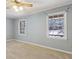 Cozy bedroom featuring neutral carpet, ceiling fan, and two windows providing natural light at 6067 Dana Dr, Norcross, GA 30093