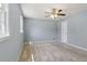 Bedroom showing gray walls, carpeted floors, and a window that lets in natural light at 6067 Dana Dr, Norcross, GA 30093