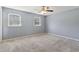 Bedroom with gray walls, carpeted floors, and natural light from two windows at 6067 Dana Dr, Norcross, GA 30093