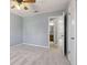 Bedroom featuring neutral walls, carpet, a ceiling fan, and a view into the bathroom at 6067 Dana Dr, Norcross, GA 30093