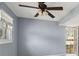 Bedroom featuring neutral walls, carpet, a window, a ceiling fan, and a door to the outside at 6067 Dana Dr, Norcross, GA 30093