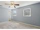 Bedroom showcasing gray walls, carpeted floor, and natural light from two windows at 6067 Dana Dr, Norcross, GA 30093
