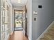 Bright entryway features hardwood floors, glass panel french doors, and stairway at 6067 Dana Dr, Norcross, GA 30093