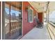 Inviting covered front porch with string lights, rocking chairs, and wood door with glass at 6067 Dana Dr, Norcross, GA 30093