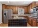 Charming kitchen with stainless steel appliances, granite countertops, and a practical center island at 6067 Dana Dr, Norcross, GA 30093
