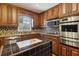 Gourmet kitchen boasting stainless steel appliances, ample cabinet space, and unique tile island at 6067 Dana Dr, Norcross, GA 30093