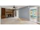 Inviting living room with a stone fireplace and access to a bright, sunlit room at 6067 Dana Dr, Norcross, GA 30093