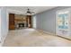 Comfortable living room with a stone fireplace, built-in shelves, and access to other rooms at 6067 Dana Dr, Norcross, GA 30093