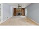 Spacious living room featuring a stone fireplace, built-in shelves, and natural light at 6067 Dana Dr, Norcross, GA 30093